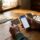 Parent's hands holding Aetna insurance card and phone while researching detox coverage options